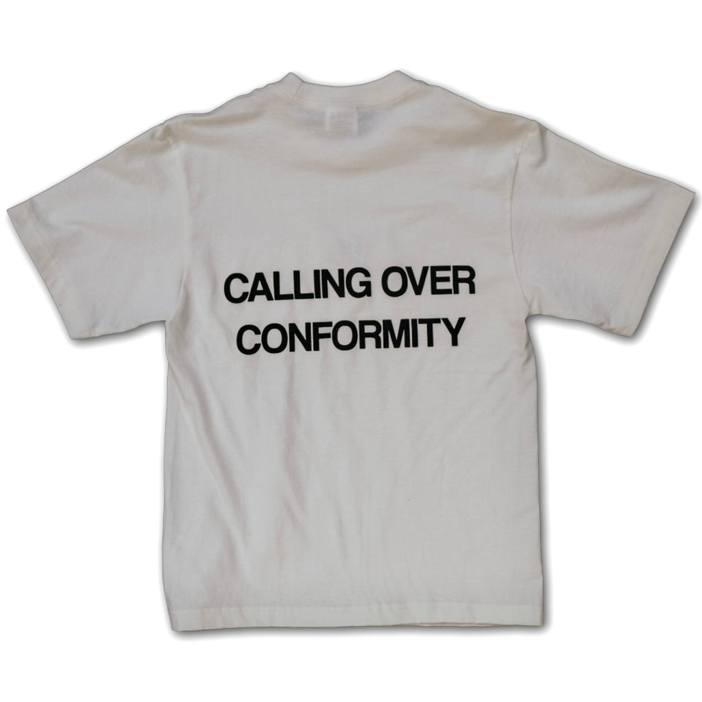 White t-shirt with black text 'Calling Over Conformity' on a white background